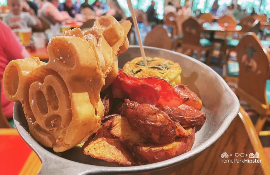 Mickey Waffle Breakfast with eggs and a side of bacon. Keep reading to find out more about the Disneyland food.