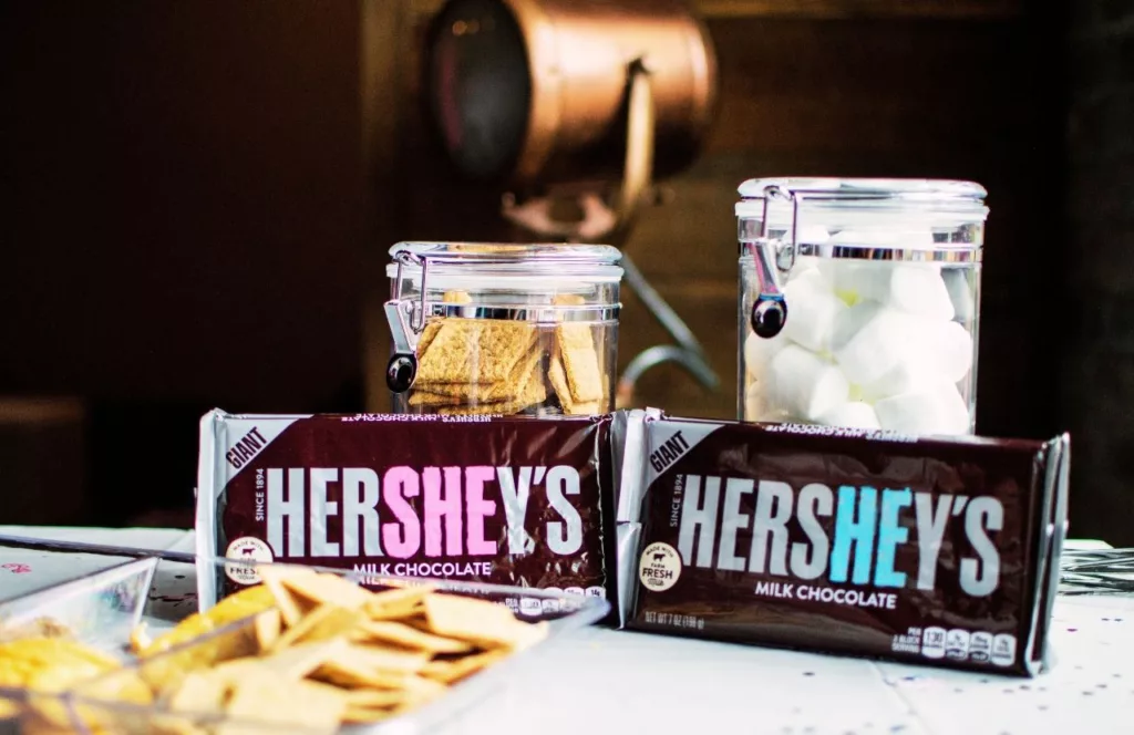 Hershey’s Giant Chocolate World Bar at Hersheypark with a jar of marshmallows behind and graham crackers. Keep reading to learn more about the top 10 best things to do around Hersheypark.