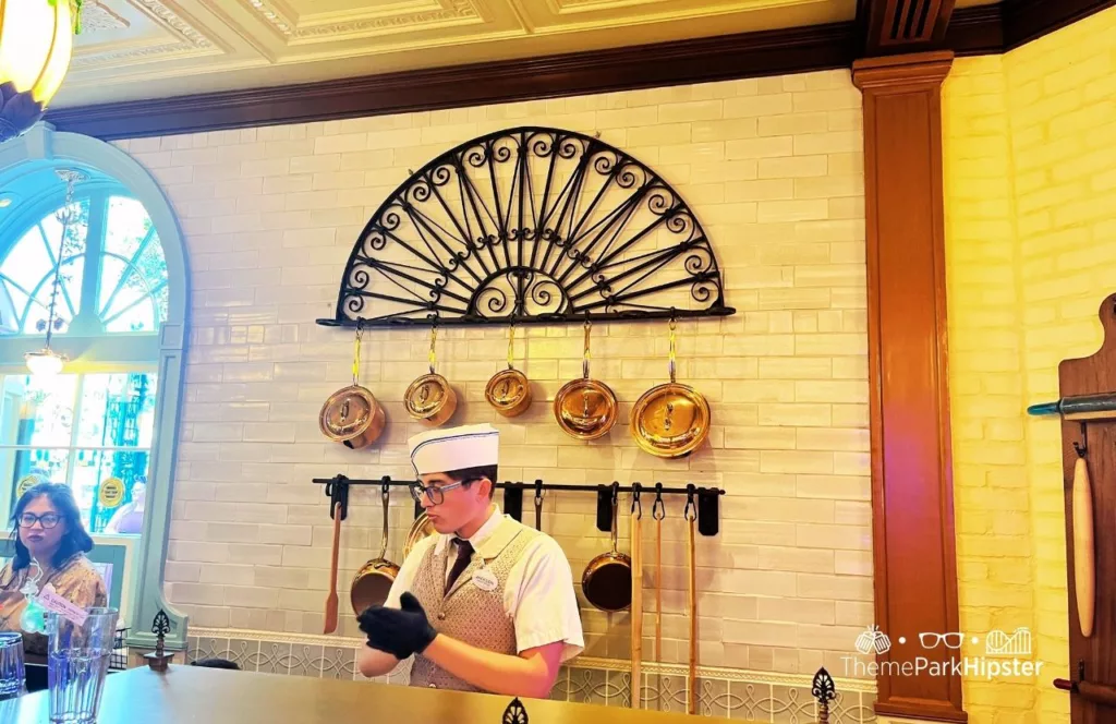 Open kitchen concept of chef working out on display for guests to of Princess and the Frog Tiana's Palace Restaurant at Disneyland. Keep reading to learn more about Tiana’s restaurant Disneyland.