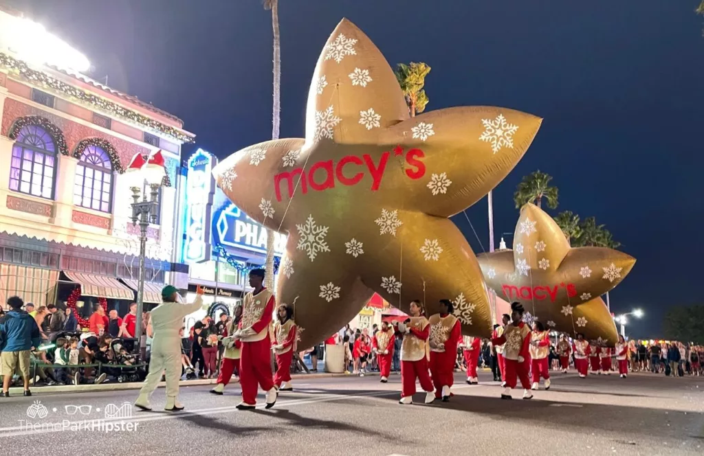 Christmas at Universal Orlando Holiday Parade featuring Macy's iconic star. Keep reading to find out more about Universal Studios Christmas Parade.