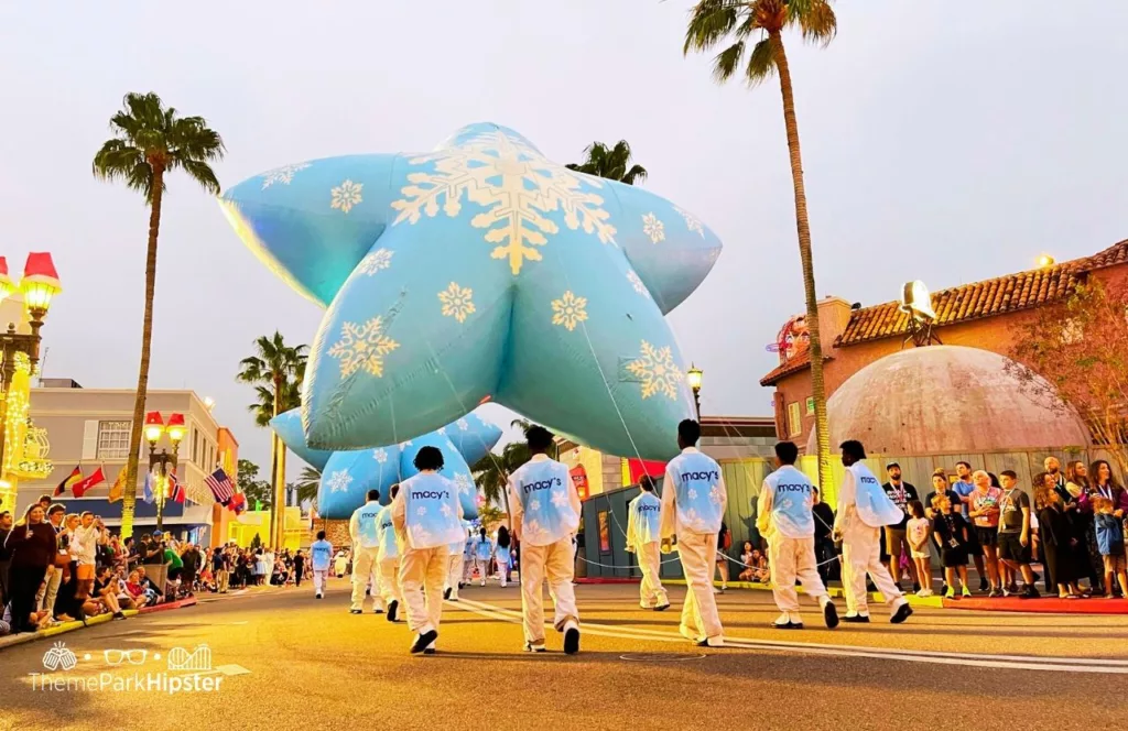 Christmas at Universal Orlando Holiday Parade featuring Macy's classic balloon star. Keep reading to find out all you need to know about Universal Studios Holiday Parade.