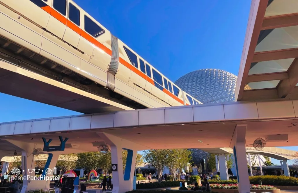 Disney Monorail Transportation at Epcot passing by entrance and Spaceship Earth. One of the Epcot Rides. Keep reading for the full guide to Disney Resort parking fee for overnight guests. 