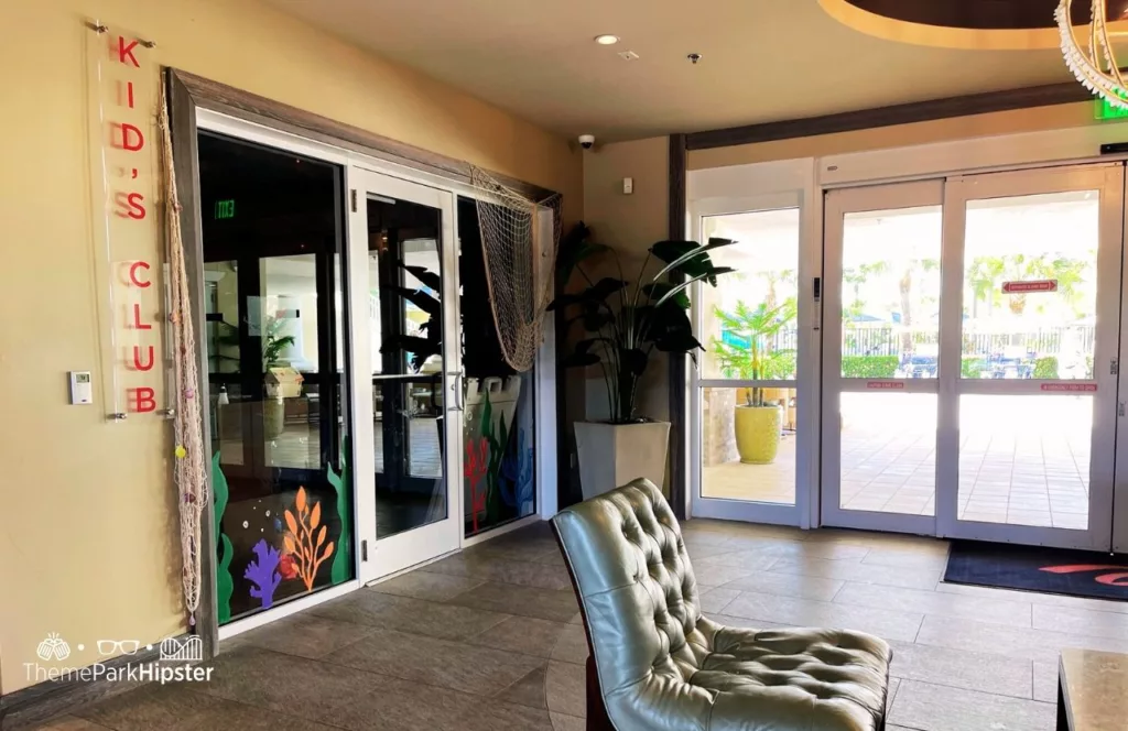 Kid's Club at Encore Resort and lobby area with grey plush chair and table. Keep reading to hear more about Encore Resort Orlando. 