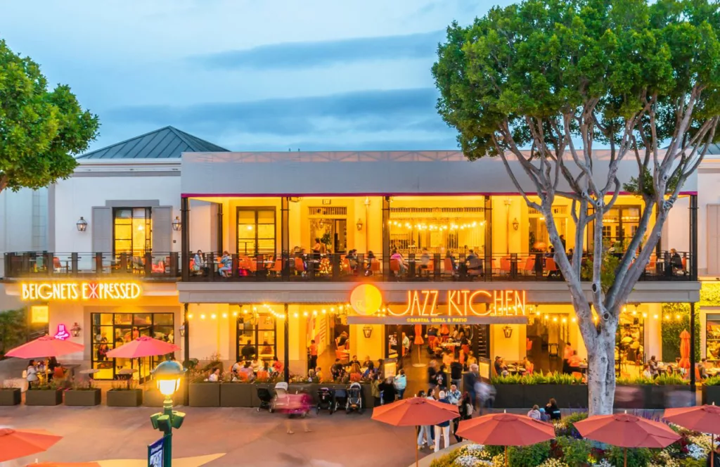 Ralph Brennan’s Jazz Kitchen at Downtown Disney District in Anaheim, California where the Beignets Expressed is located with outdoor seating and second level seating with wide open window views. Keep reading to find out more about Disneyland food.