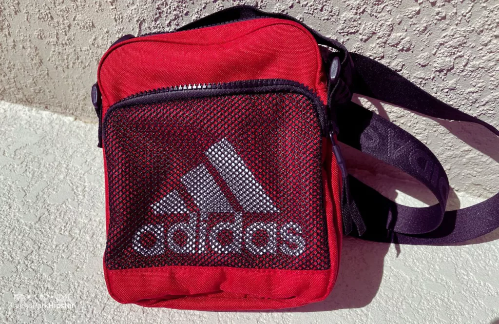 Red Adidas Crossbody Bag. One of the best purses for Disney World