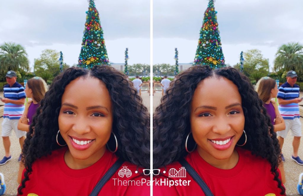 NikkyJ in front of Christmas tree at SeaWorld Orlando Christmas Celebration on a solo theme park trip! Keep reading to learn more about the Top Must-See Events at SeaWorld Orlando.