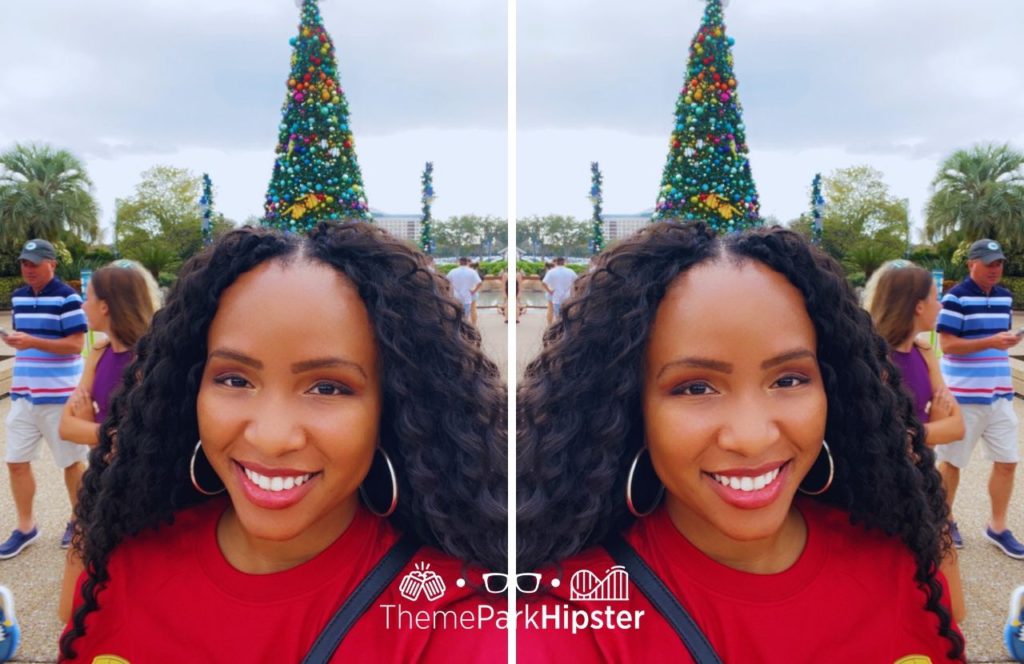 NikkyJ in front of Christmas tree at SeaWorld Orlando Christmas Celebration