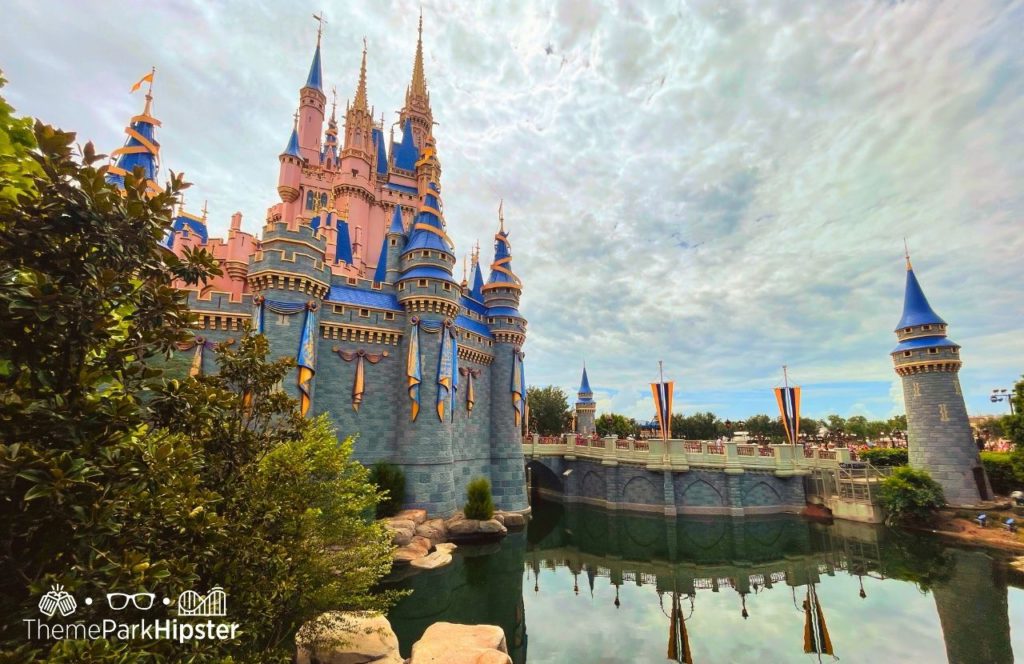 Disney Magic Kingdom Park for adults with Cinderella Castle on cloudy Florida day. Keep reading for the full guide to Todd English Bluezoo restaurant at Disney World.