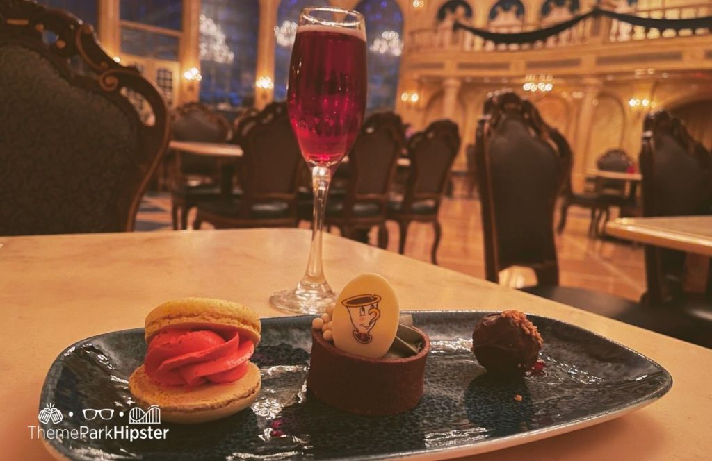 Disney Magic Kingdom Park Fantasyland Beast Castle Be Our Guest Restaurant with Grey Stuff Dessert and Macaron and Red Wine. One of the best restaurants at Magic Kingdom.