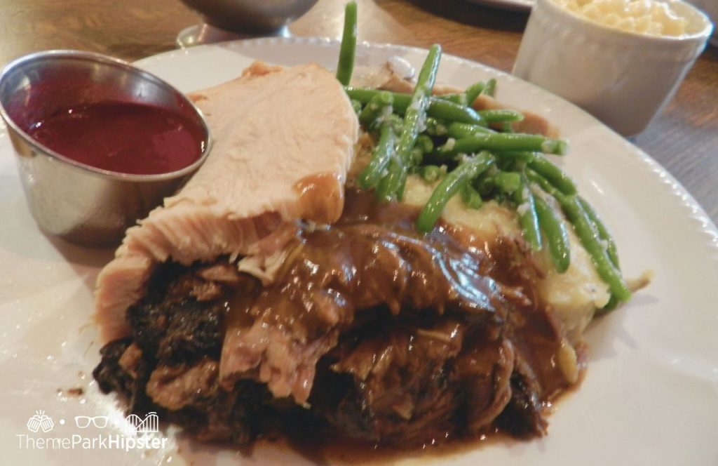 Disney Magic Kingdom Park Liberty Tree Tavern Restaurant with roast beef turkey gravy green beans and mac and cheese. One of the best places to eat in the Magic Kingdom for Lunch.