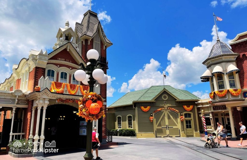 Disney Magic Kingdom Park Main Street USA Firehouse and Barbershop with fall decorations. Keep reading to get the best Disney Magic Kingdom secrets and fun facts.