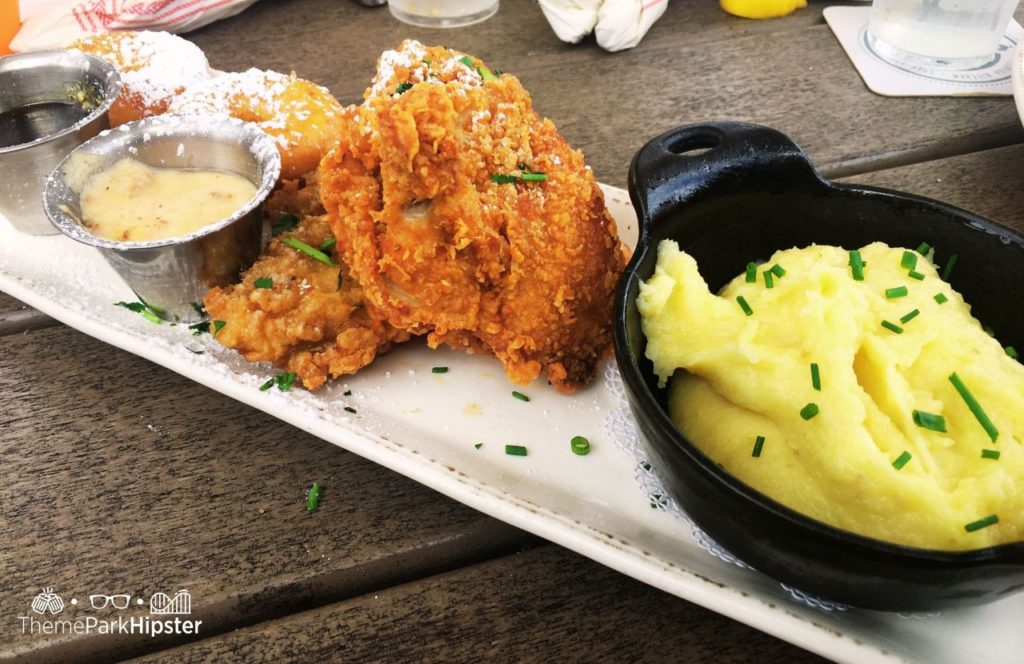 Walt Disney World Disney Springs Chef Art Smith's Homecomin Restaurant Fried Chicken and Doughnuts with Mashed Potatoes. One of the best places to get breakfast and Brunch in Disney Springs.
