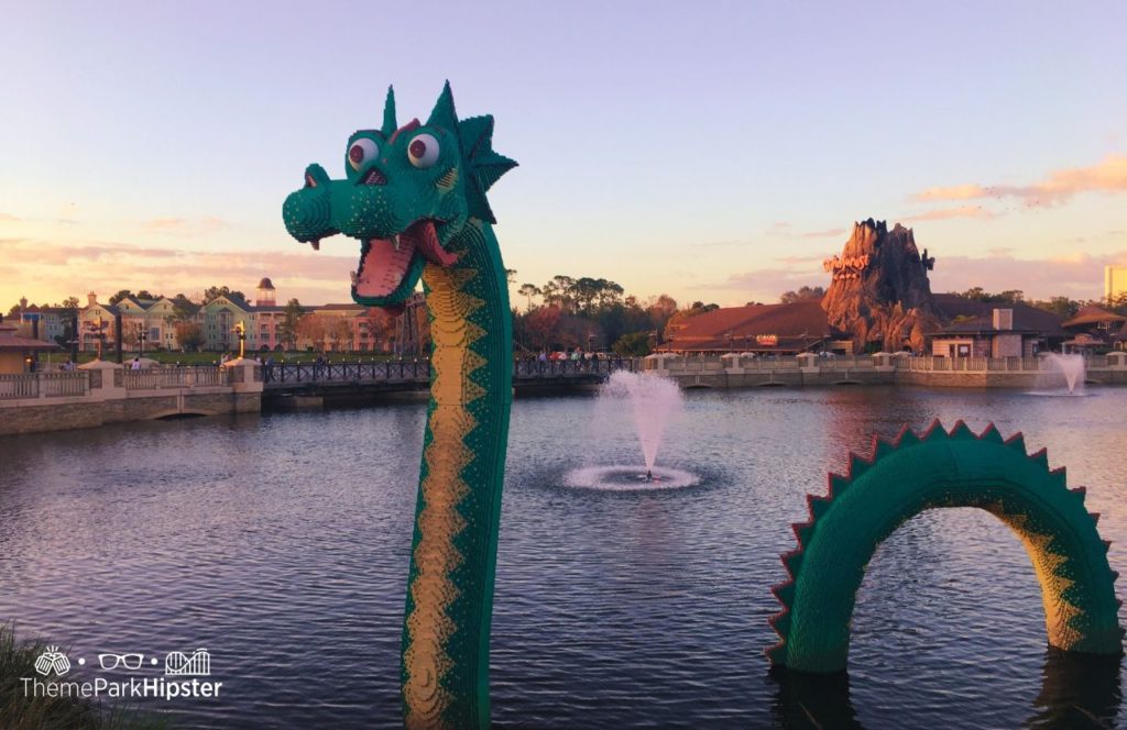 Walt Disney World Disney Springs Lego Dragon in Lagoon with Rainforest Cafe in Background and Saratoga Springs