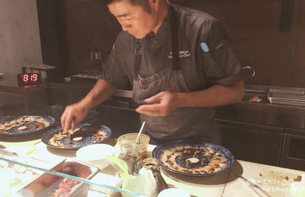 Walt Disney World Disney Springs Morimoto Asia Restaurant sushi chef making seafood dish