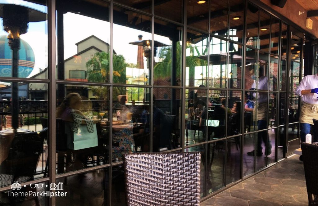 Walt Disney World Disney Springs Wine Bar George Restaurant patio dining. Keep reading to find out all you need to know about Wine Bar George at Disney Springs.