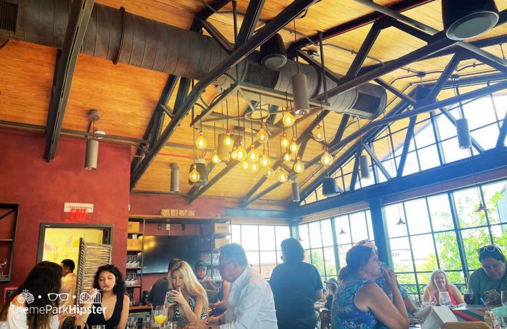Industrial style lighting at Wine Bar George. Keep reading to find out all you need to know about Wine Bar George at Disney Springs.