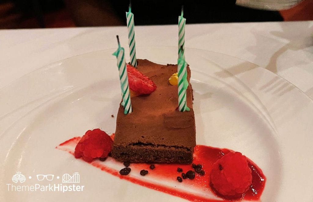 Il Mulino New York Italian Restaurant chocolate slice of birthday mouse cake Swan and Dolphin Resort Hotel at Walt Disney World. Keep reading to learn more about where to get the best Italian food at Disney.