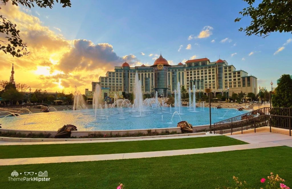 Celestial Park at Dusk with Water Fountains on the Cosmic Lagoon with Helios Hotel in the Background Universal Epic Universe Theme Park Orlando