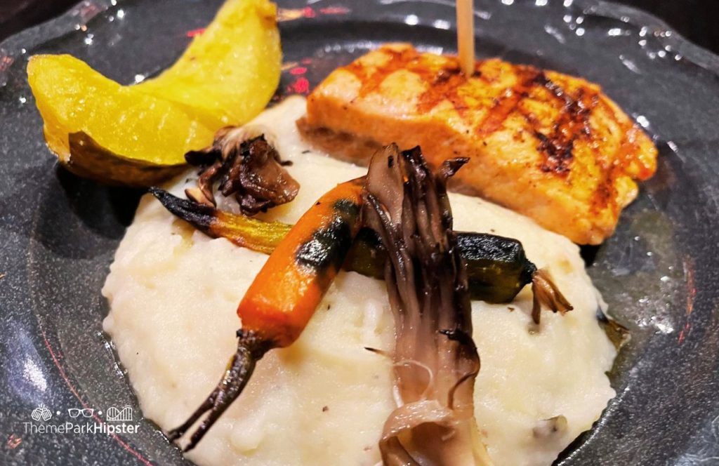 Dark Universe Das Stakehaus Restaurant Fish on a Stake with Mashed Potatoes Universal Epic Universe Theme Park Orlando