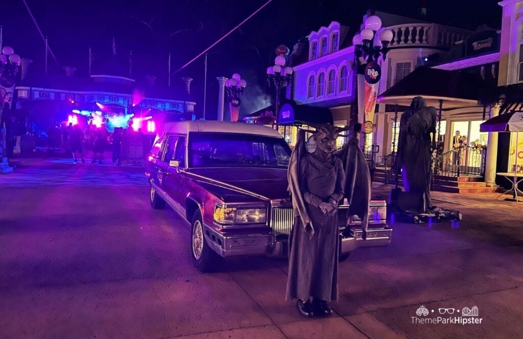 Six Flags Over Georgia Amusement Park Fright Fest Halloween Event Purple Hearse and Statues in Scare Zone