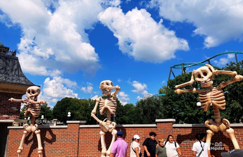 Six Flags Over Georgia Amusement Park Fright Fest Halloween Skeletons with Goliath coaster in the background. Keep reading for more tips on planning a trip to Six Flags Over Georgia.